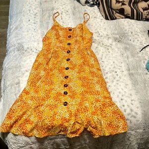 This is a cute orange and yellow dress. Its just above the knees.